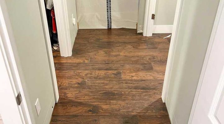 Dark wood plank flooring installed in a residential hallway by Simple Floor Solutions