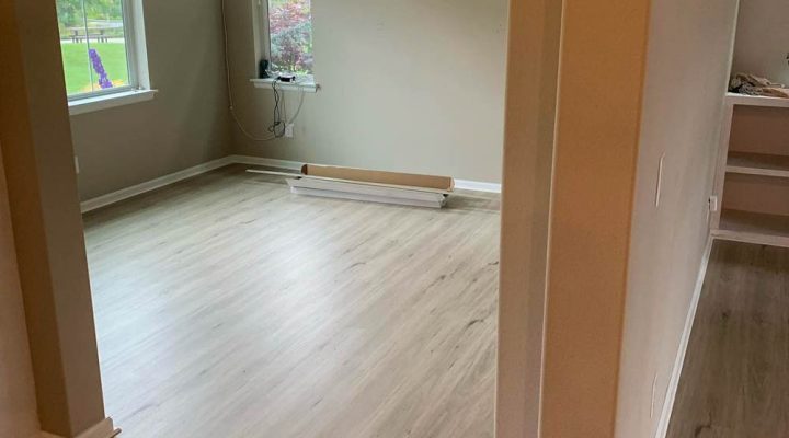 Light whitewashed wood plank flooring in a bright residential bedroom