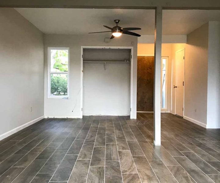 Gray wood-look porcelain tile flooring in a residential bedroom