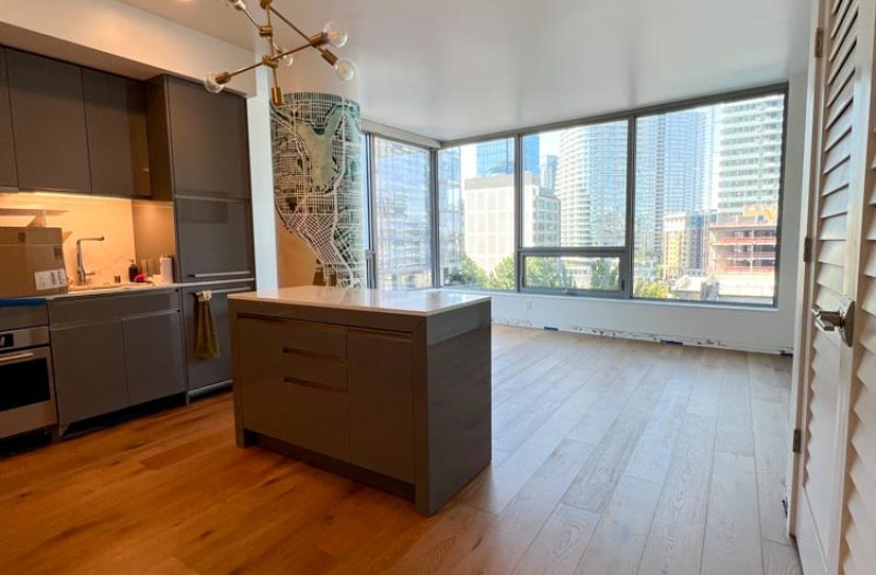 Light hardwood plank flooring in a downtown Seattle loft with floor-to-ceiling windows