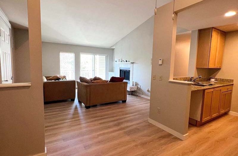 Warm-toned hardwood flooring in an open-plan living room with vaulted ceilings, installed by Simple Floor Solutions in Enumclaw, WA