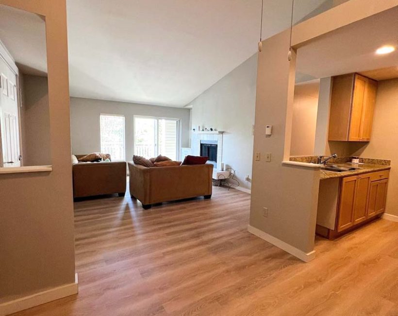 Warm-toned hardwood flooring in an open-plan living room with vaulted ceilings, installed by Simple Floor Solutions in Enumclaw, WA