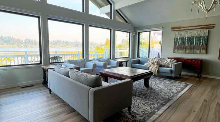 Light wood-look luxury vinyl plank flooring in a sunroom overlooking the water