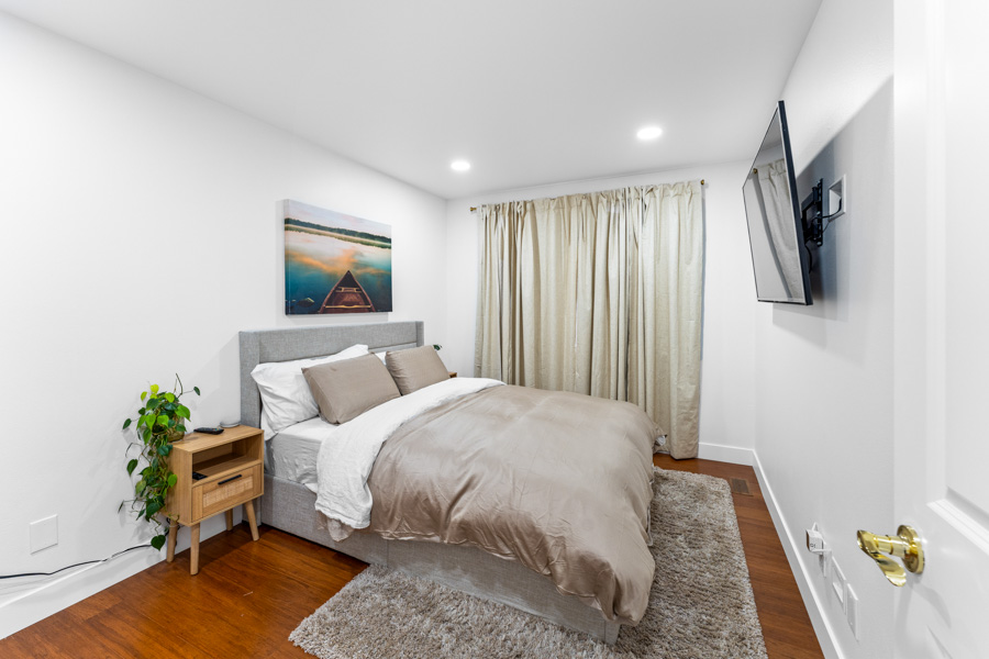 Modern bedroom with rich hardwood plank flooring installed by Simple Floor Solutions in Covington, WA
